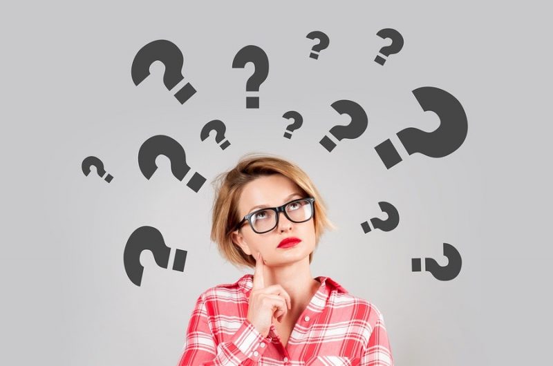 Thinking Women With Question Marks On White Background